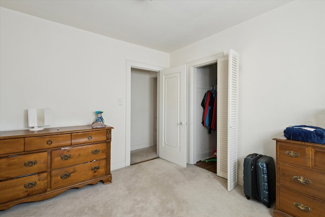 bedroom featuring a closet and light carpet