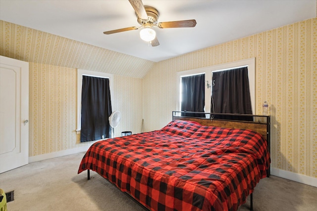 carpeted bedroom with wallpapered walls, lofted ceiling, and baseboards