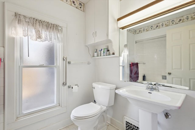 bathroom featuring toilet, baseboards, and visible vents