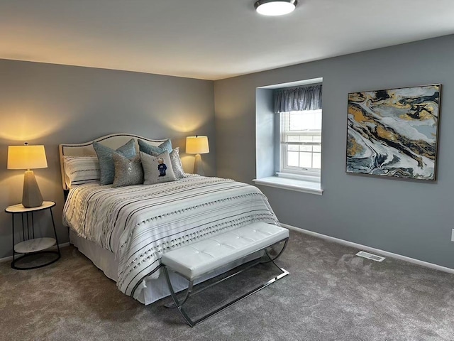 carpeted bedroom featuring visible vents and baseboards