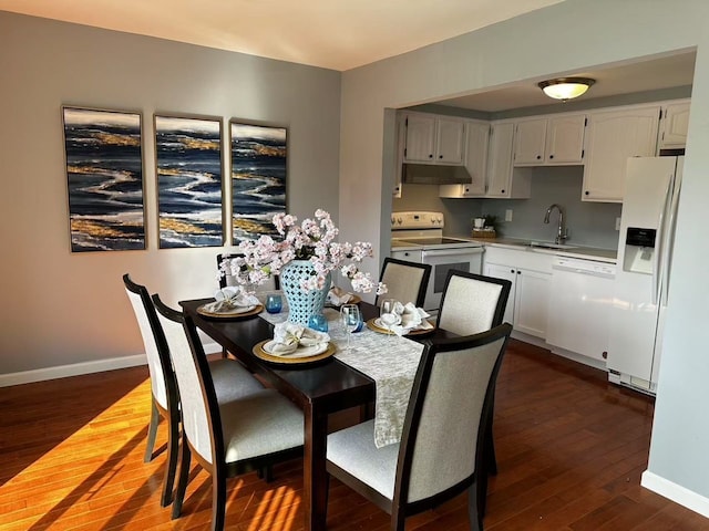 dining area featuring baseboards and dark wood-style flooring