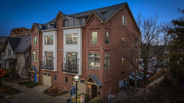 exterior space with a garage, brick siding, and driveway