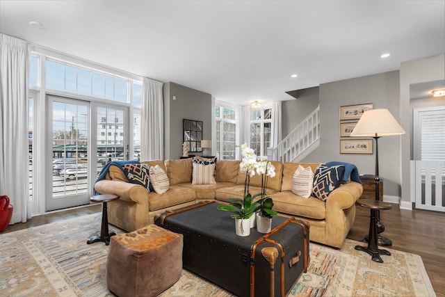 living area featuring stairway, recessed lighting, baseboards, and wood finished floors