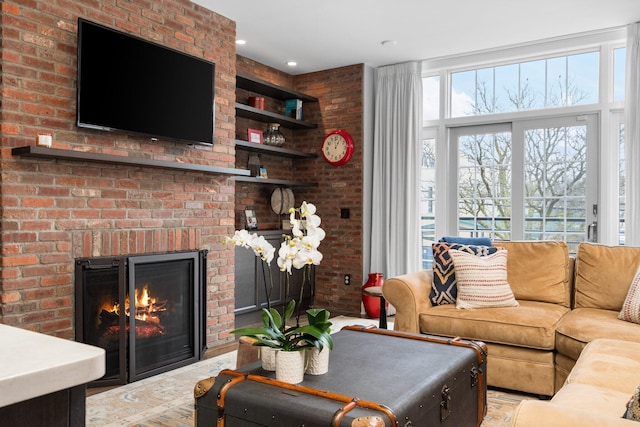 living room featuring a brick fireplace