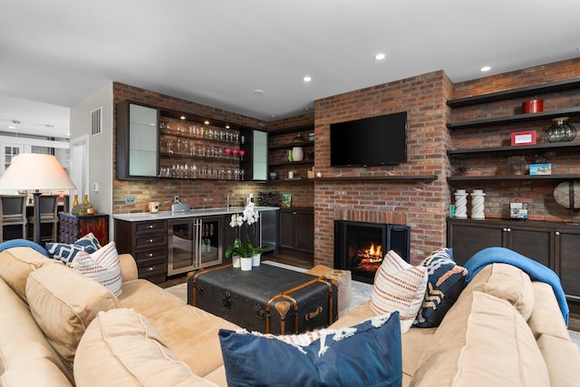 living area with visible vents, bar area, a brick fireplace, and brick wall