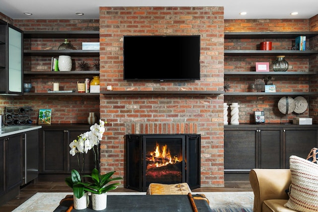 living room with recessed lighting, wood finished floors, and a fireplace