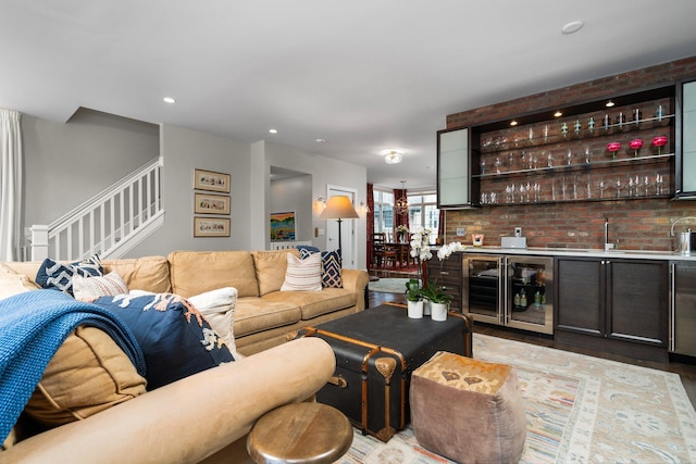 living area featuring indoor wet bar, stairway, recessed lighting, and wine cooler