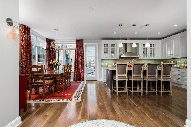 dining room featuring a chandelier, recessed lighting, and dark wood-style flooring