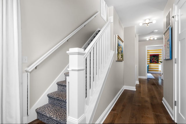 stairs featuring baseboards and wood finished floors