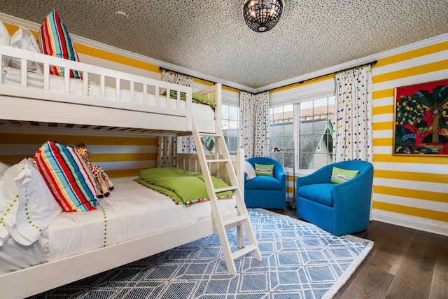 bedroom with ornamental molding, baseboards, and wood finished floors