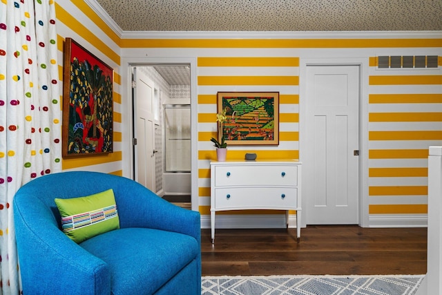 living area with visible vents, baseboards, wood finished floors, and ornamental molding