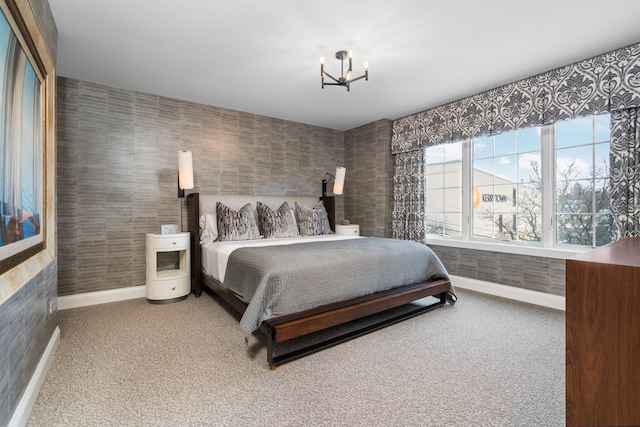 carpeted bedroom featuring a chandelier, wallpapered walls, and baseboards