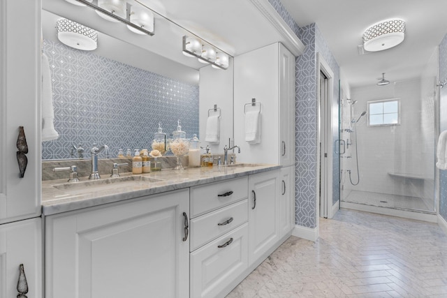 full bath featuring a sink, a stall shower, and double vanity