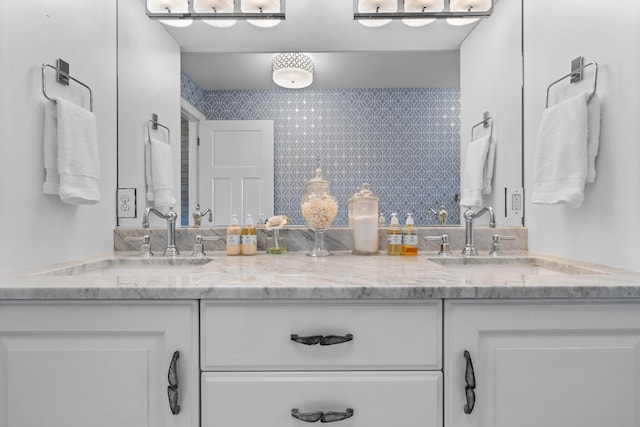 bathroom with a sink and double vanity