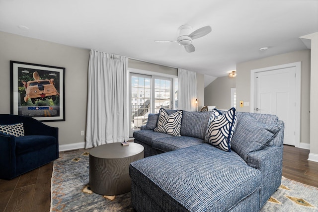 living room with a ceiling fan, wood finished floors, and baseboards