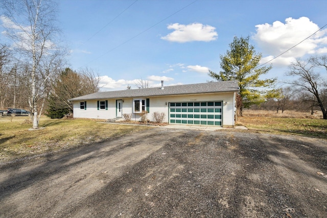 view of front of home featuring aphalt driveway and a garage