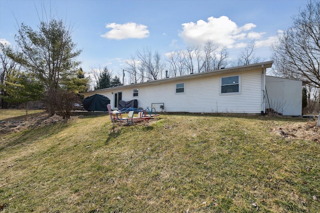 back of house with a lawn