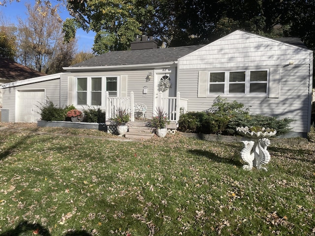 view of front of home with a front lawn, an attached garage, a chimney, and a shingled roof