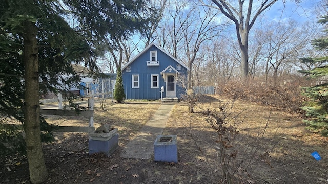 view of front facade with board and batten siding and entry steps