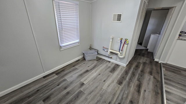 interior space featuring visible vents, baseboards, and wood finished floors