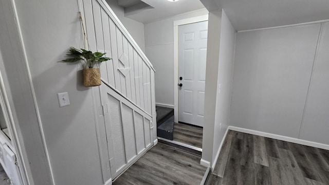 stairs featuring baseboards and wood finished floors