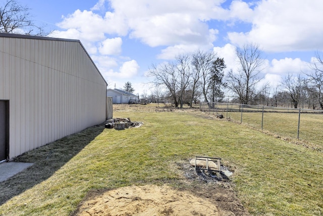 view of yard with an outbuilding and fence