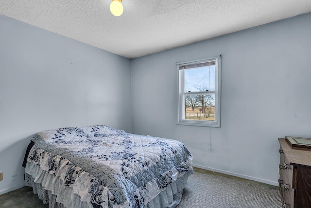 bedroom featuring a textured ceiling, baseboards, and carpet