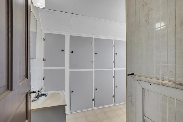 bathroom with vanity, tile walls, and tile patterned floors