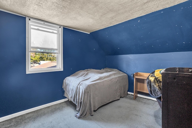 bedroom with vaulted ceiling, baseboards, carpet floors, and a textured ceiling