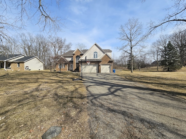 view of front of property with aphalt driveway and an attached garage