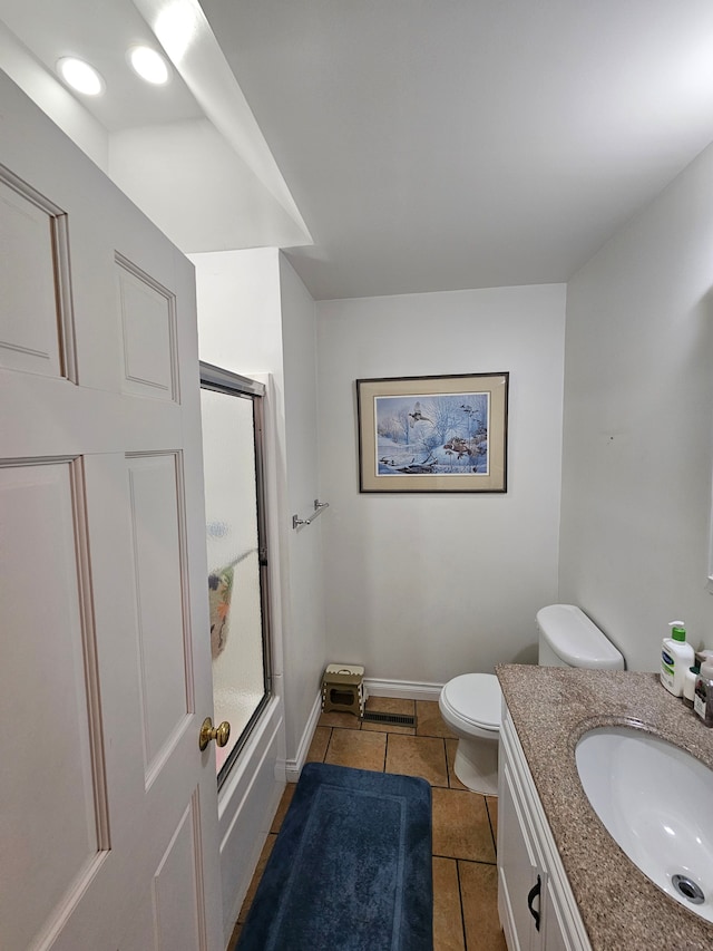 bathroom with vanity, baseboards, enclosed tub / shower combo, tile patterned flooring, and toilet