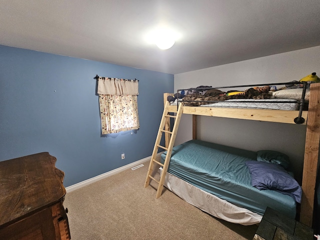 carpeted bedroom featuring visible vents and baseboards