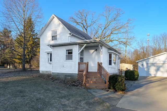 view of front of property featuring a detached garage and an outdoor structure