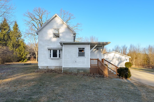 back of property featuring an outdoor structure