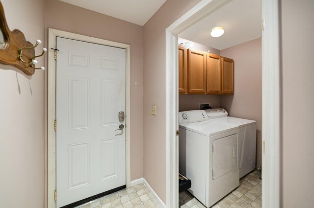 washroom with baseboards, cabinet space, light floors, and independent washer and dryer