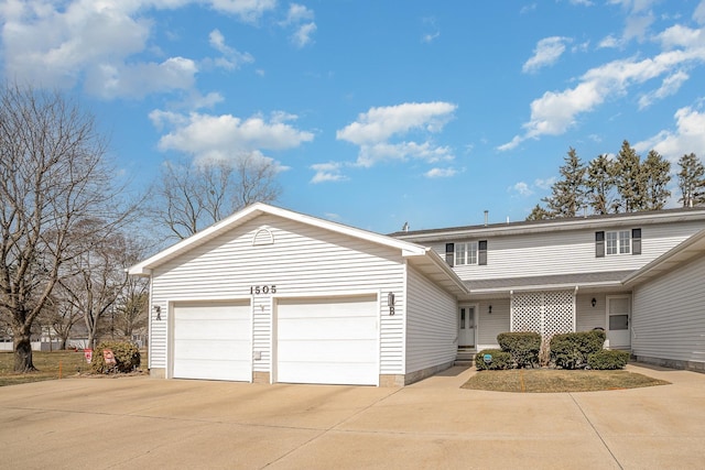 traditional home featuring an attached garage and concrete driveway