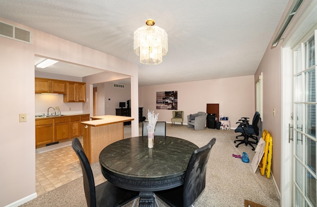 dining space featuring a notable chandelier, visible vents, and light colored carpet