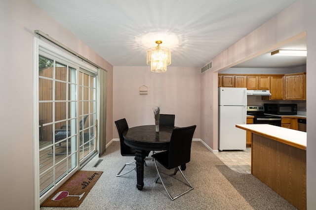 dining area with light carpet, baseboards, visible vents, and a chandelier