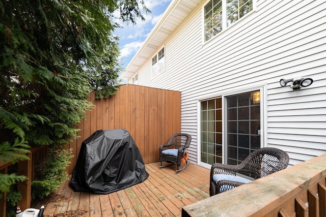 wooden terrace with grilling area and fence