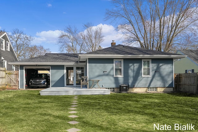 back of house with a shingled roof, fence, a lawn, cooling unit, and a garage