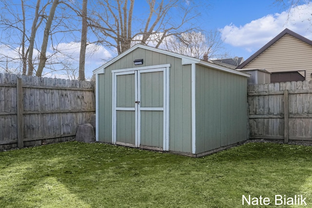 view of shed with a fenced backyard