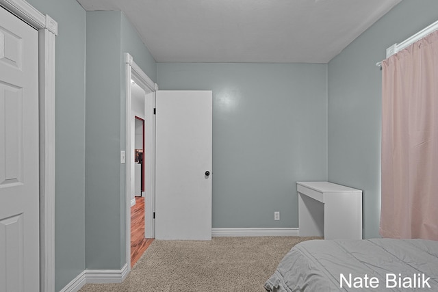 carpeted bedroom with baseboards