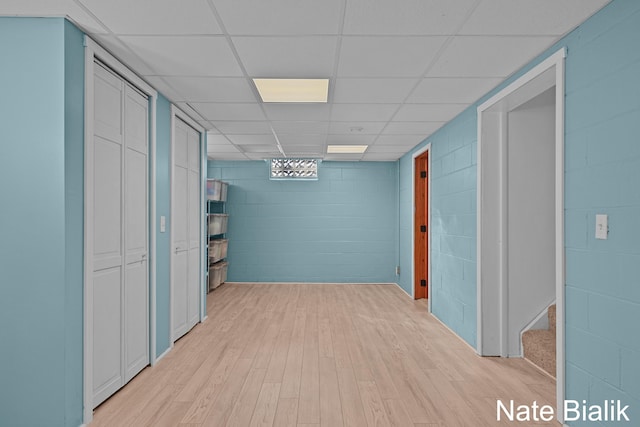 interior space featuring light wood-style floors and concrete block wall