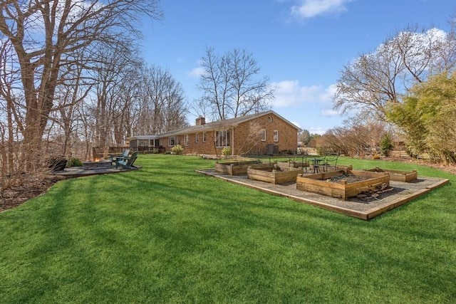 view of yard with central air condition unit and a vegetable garden