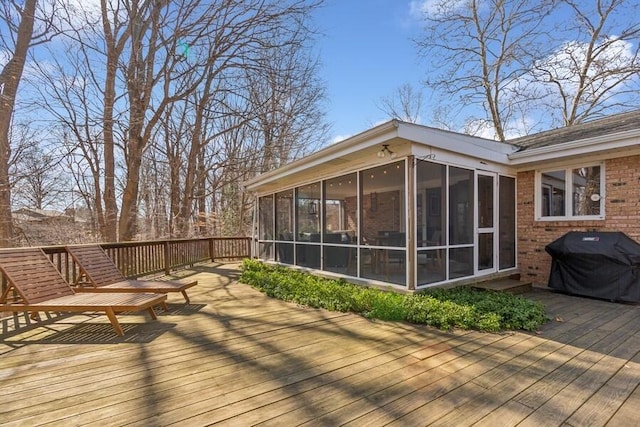 wooden terrace featuring area for grilling and a sunroom