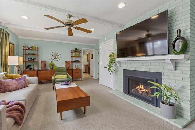 living room with a brick fireplace, carpet flooring, recessed lighting, and ceiling fan