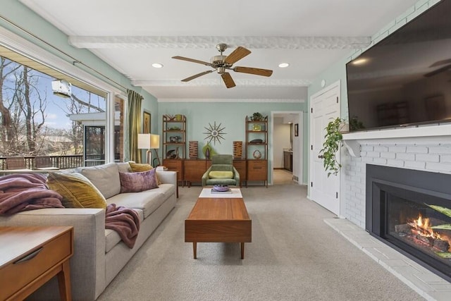 living room featuring light carpet, recessed lighting, a fireplace, and a ceiling fan