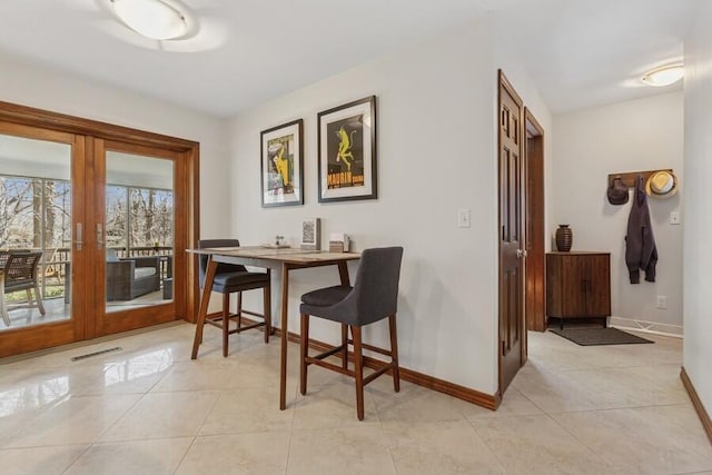 dining space with light tile patterned floors, visible vents, french doors, and baseboards