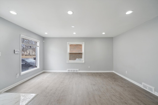 unfurnished room featuring recessed lighting, baseboards, and visible vents