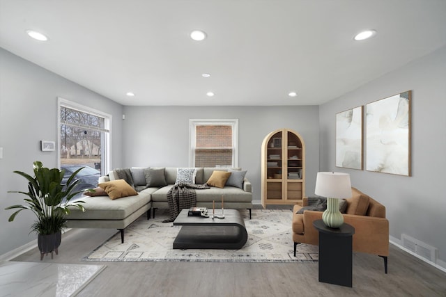 living room with recessed lighting, visible vents, and baseboards